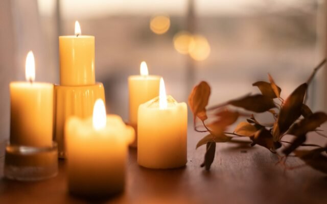 White pillar candles on a wooden table