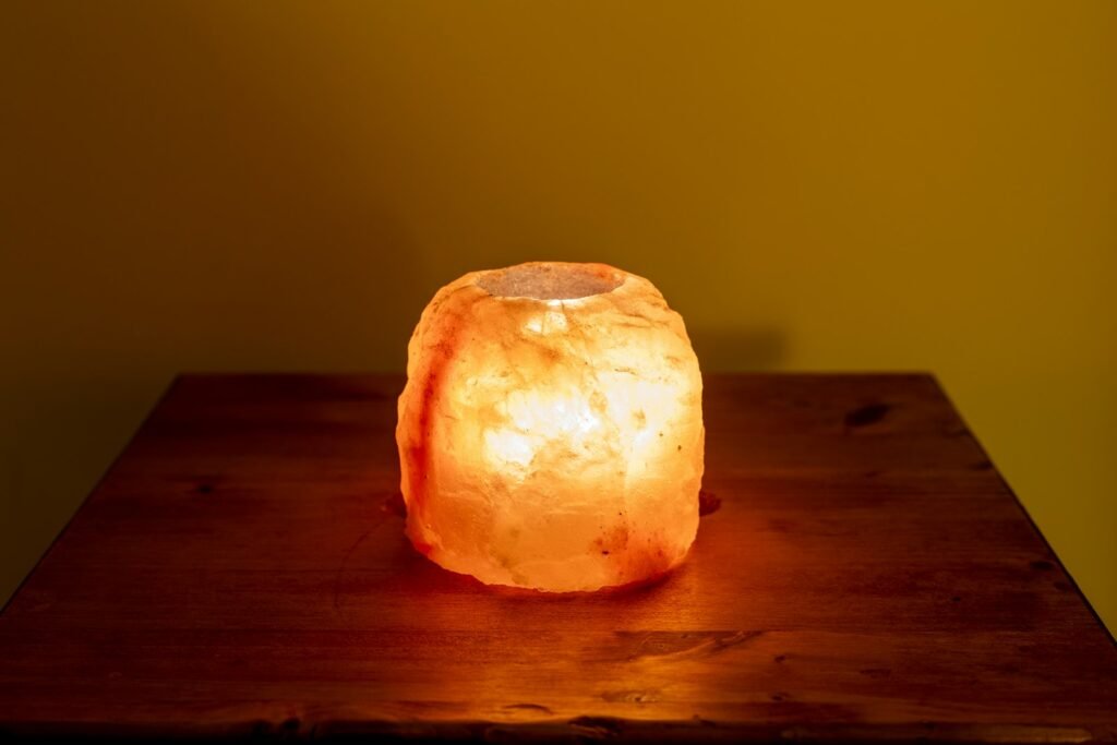 Glowing salt lamp on a wooden table
