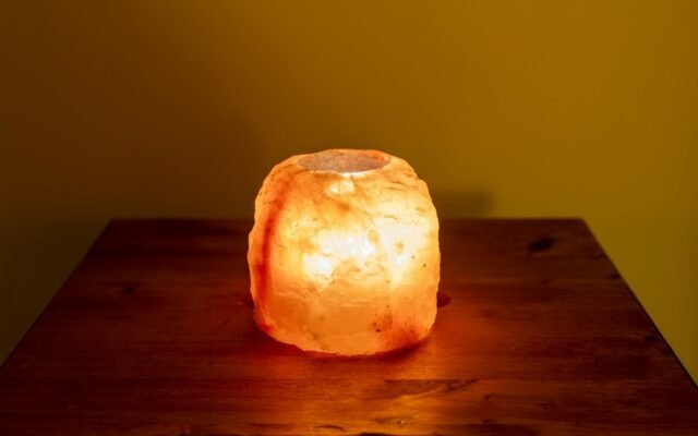 Glowing salt lamp on a wooden table