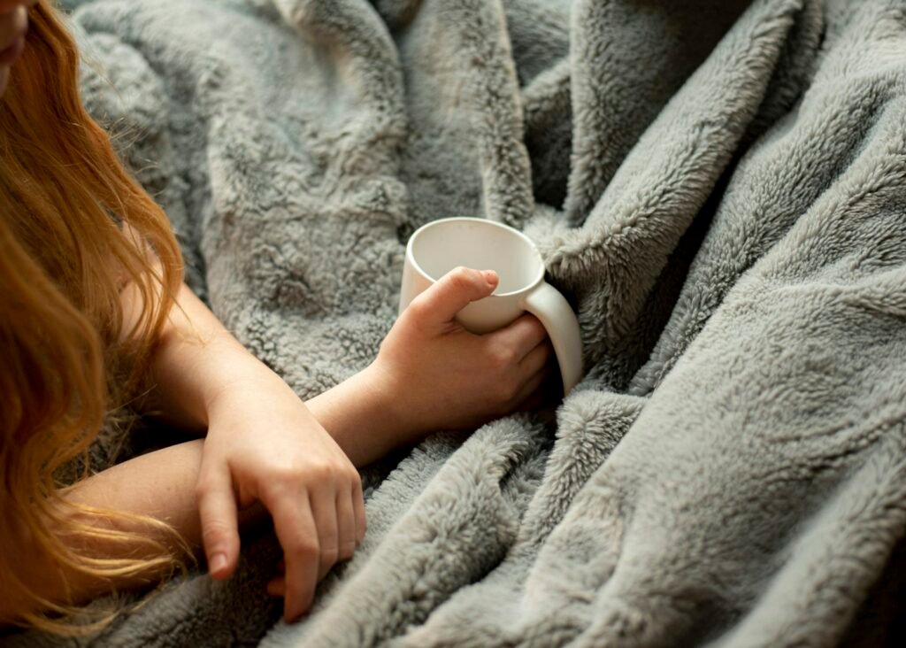 Warm drink and blanket for feeling cozy in winter